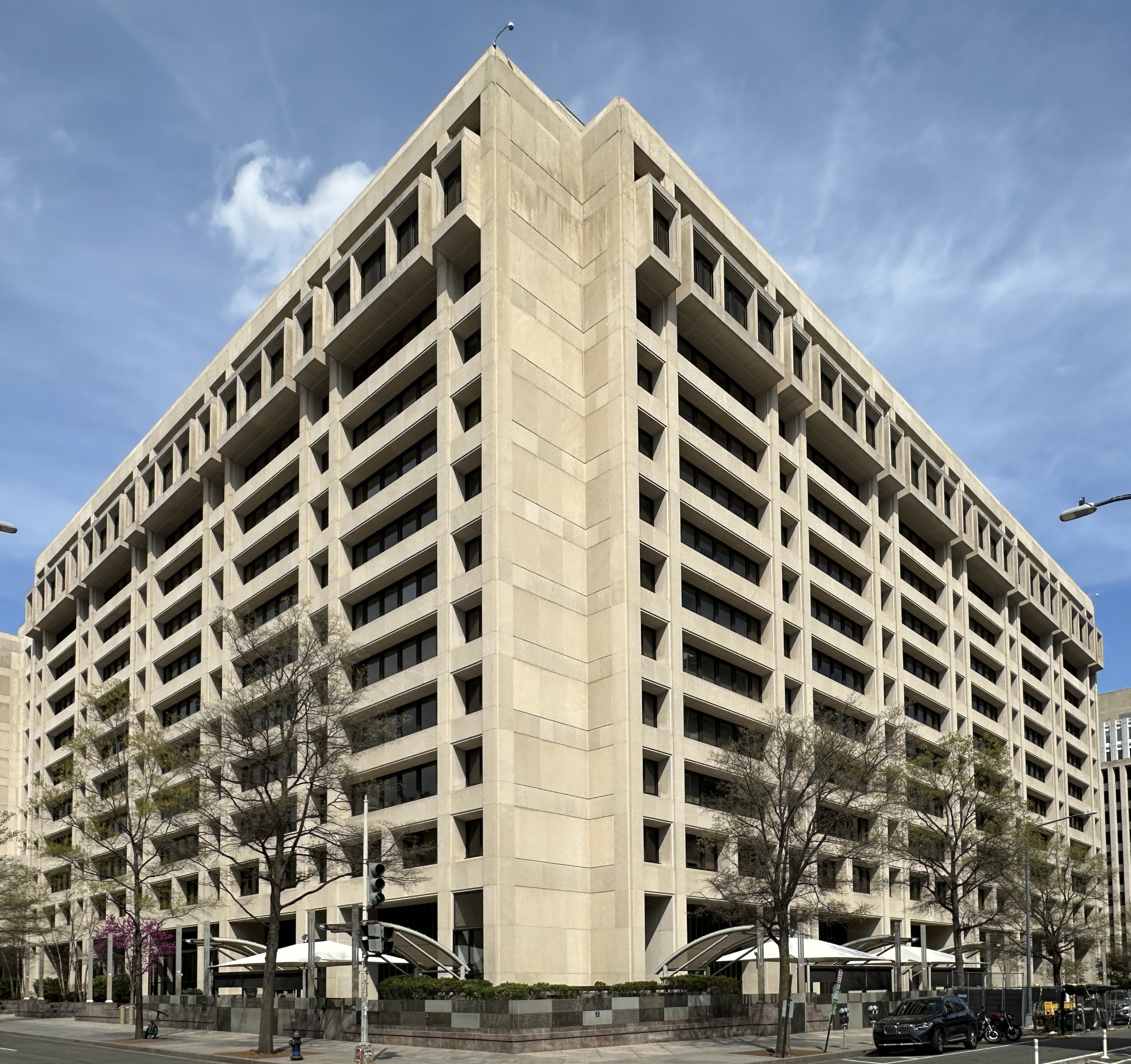 The headquarters of the International Monetary Fund at 700 19th Street NW in Washington, D.C., a large stone office building with a tall colonnade, photographed on 31 March 2026 under clear sky.