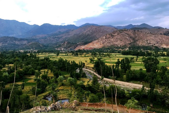 Rocky hills and a dry valley in Bajaur district, Khyber Pakhtunkhwa, with sparse vegetation on the slopes.