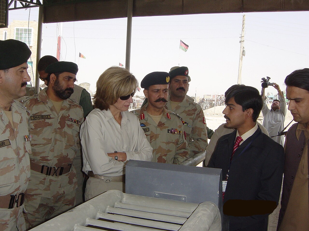 A Pakistani official standing beside a biometric immigration counter at the Chaman border crossing with Afghanistan.