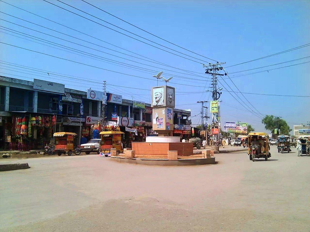 A road junction with shops and traffic in Charsadda, Khyber Pakhtunkhwa