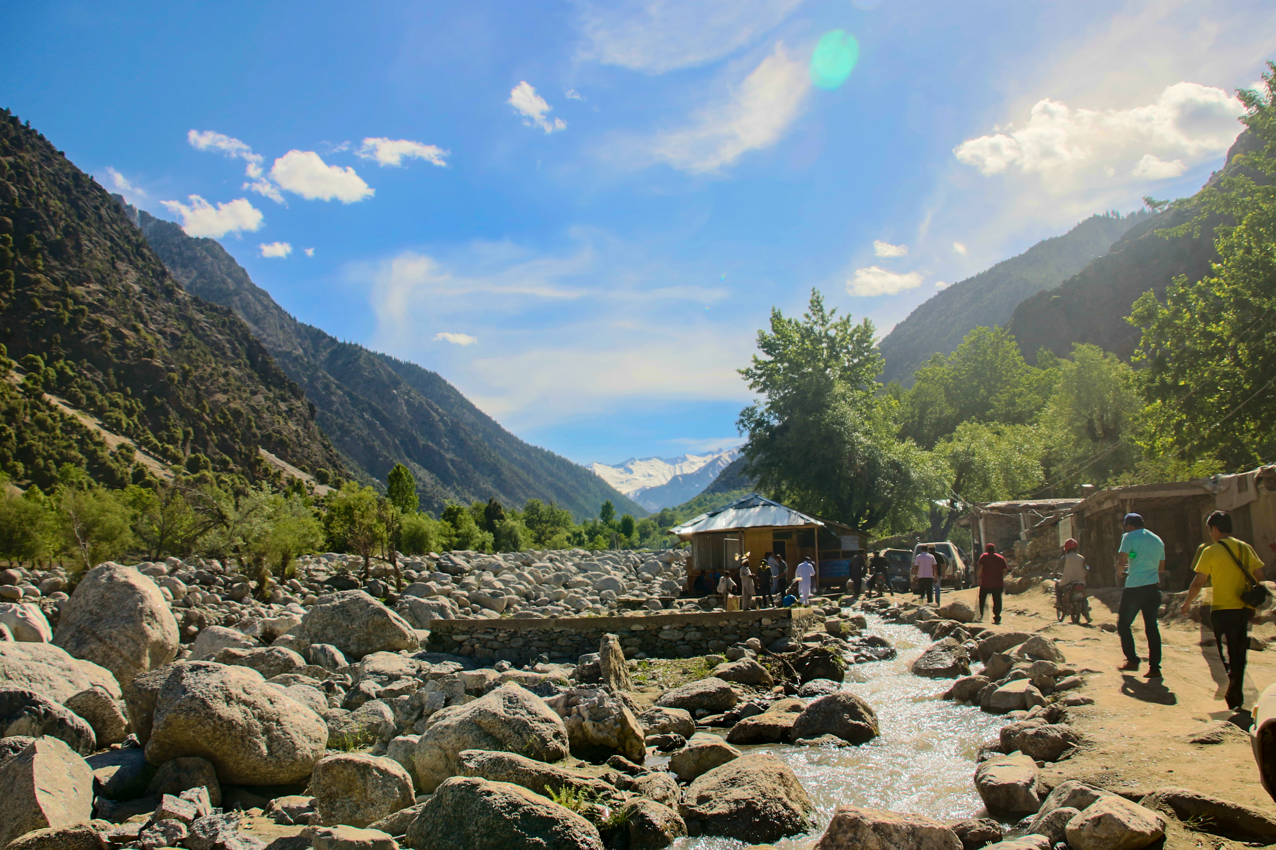 A green mountain valley with terraced fields and a river in Chitral district