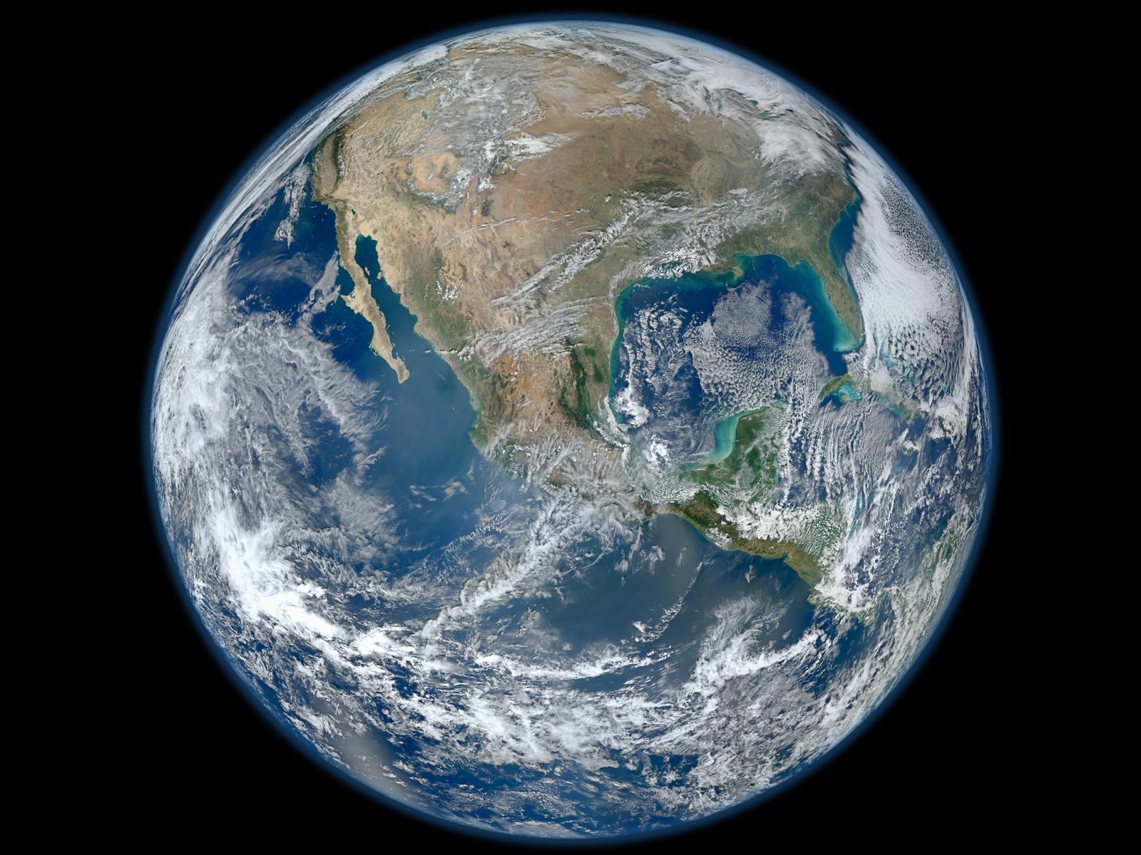 Earth seen against black space, with North and Central America beneath swirling white cloud systems