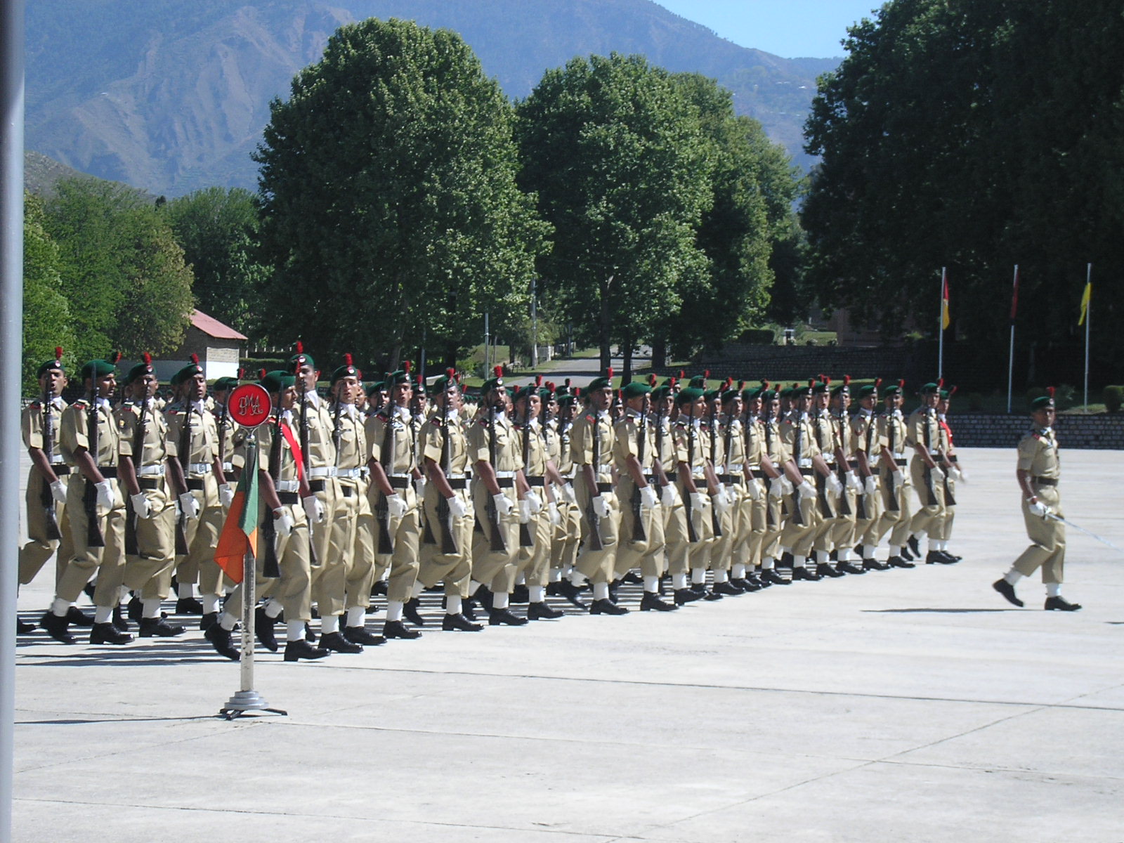 Gentleman Cadets of the Pakistan Army on parade at the Pakistan Military Academy in Kakul, with rows of cadets in ceremonial uniform visible across the parade ground.
