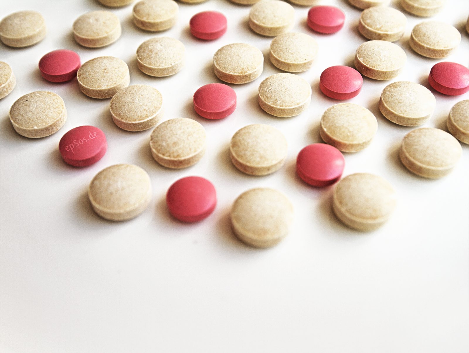 Assorted packaged and blister-packed medicines laid out on a surface.