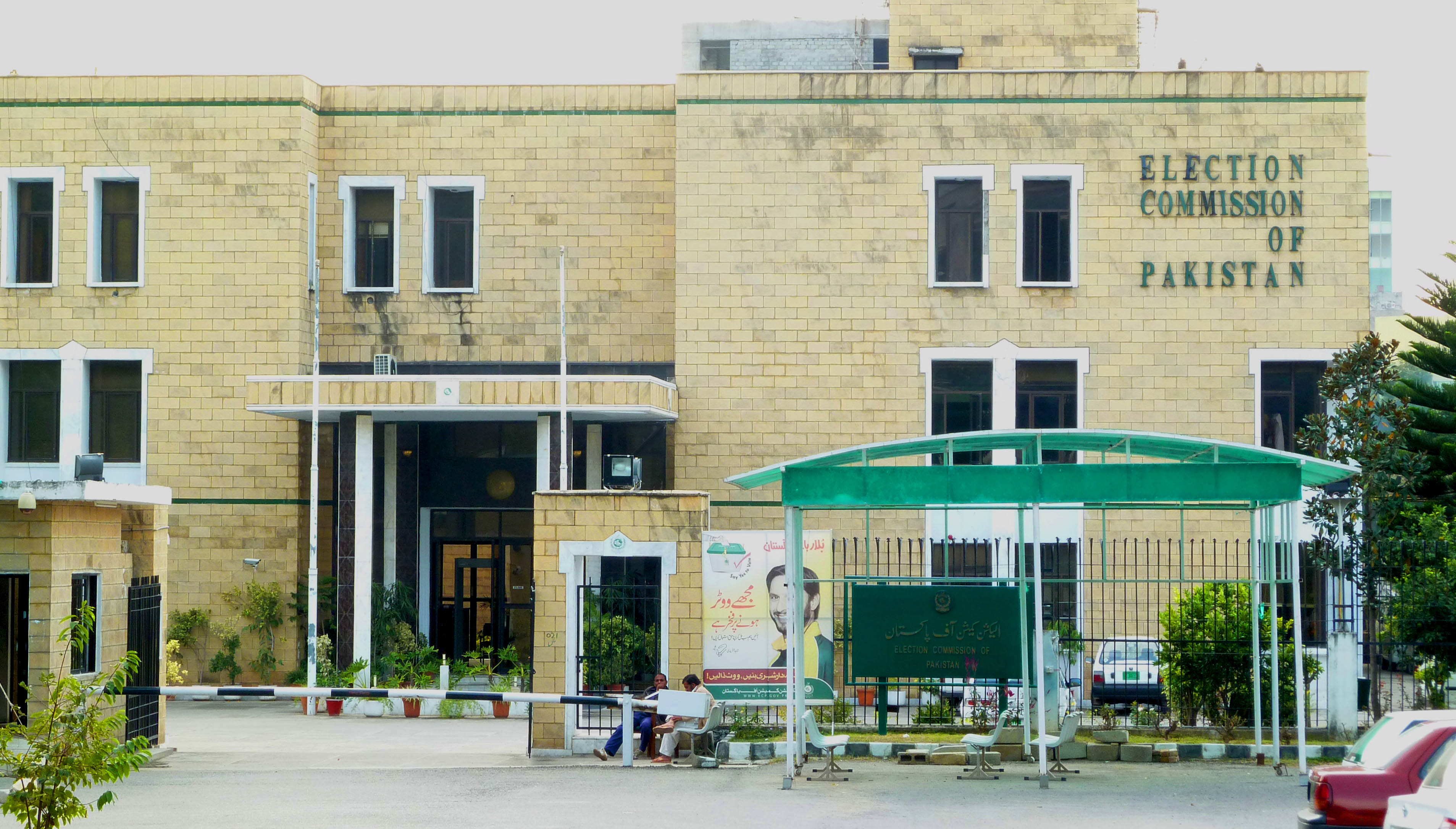 The exterior of the Election Commission of Pakistan headquarters in Islamabad, a low-rise building behind a wide gate, photographed in 2013.
