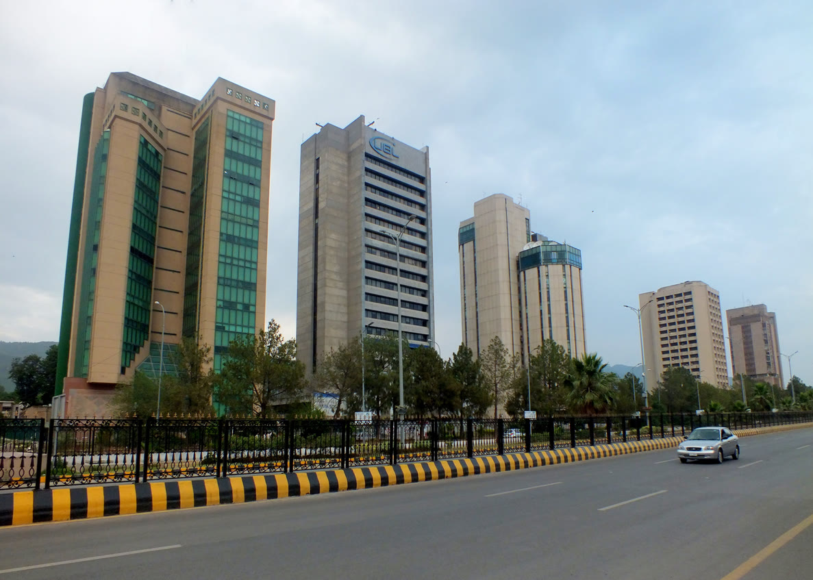 Buildings and a road in Islamabad's Blue Area business district seen at dusk.