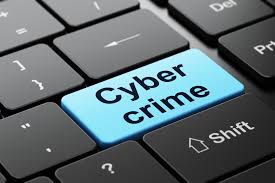 Close-up of a computer keyboard with a light-blue key reading Cyber crime.