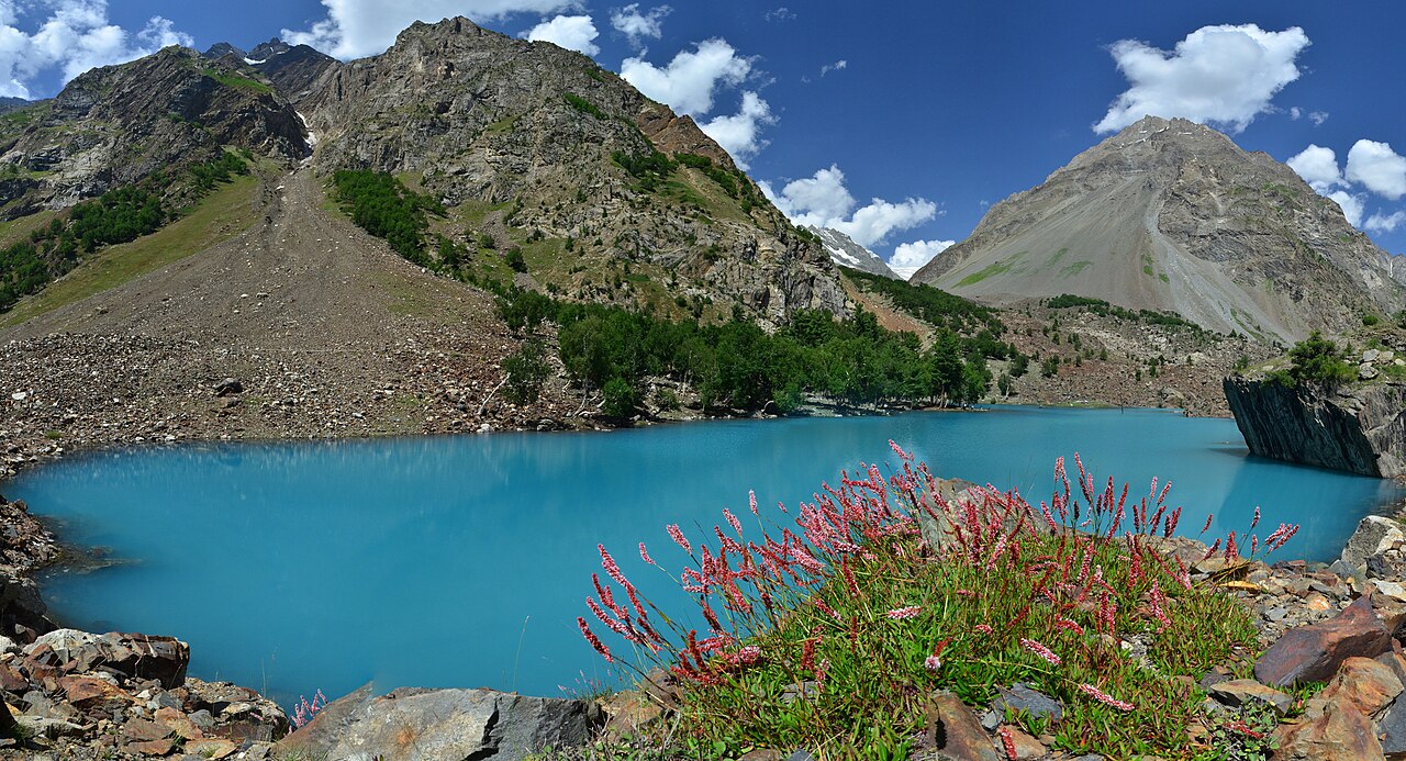 A large blue glacial lake ringed by bare brown mountains in Naltar Valley, Gilgit-Baltistan.