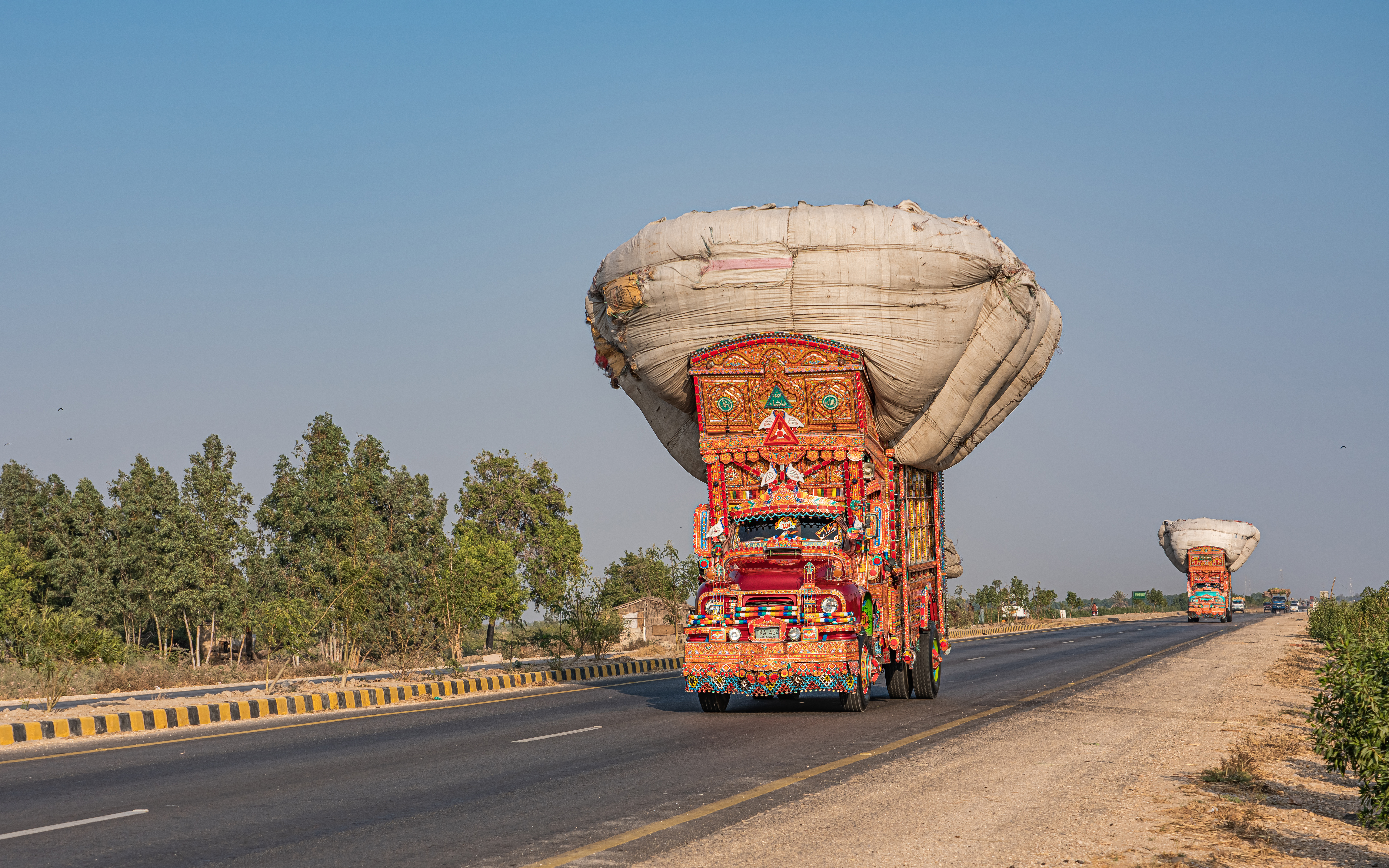 A decorated jingle truck carrying a load on the N-5 National Highway in Sindh, Pakistan.
