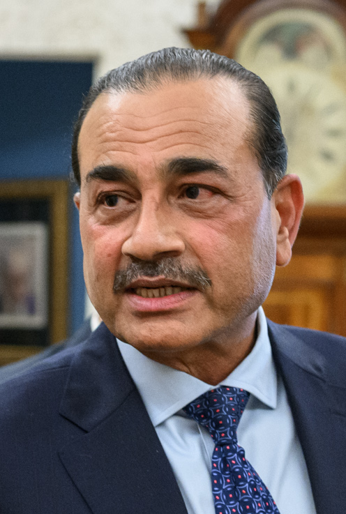 Field Marshal Asim Munir in a dark suit seated in the Oval Office, smiling