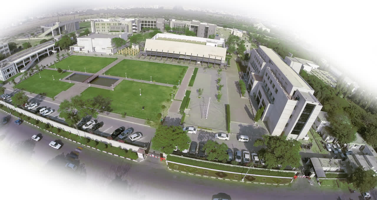 A wide view of the Institute of Business Administration Karachi Main Campus, showing low-rise academic blocks behind a guarded entrance and a paved forecourt.