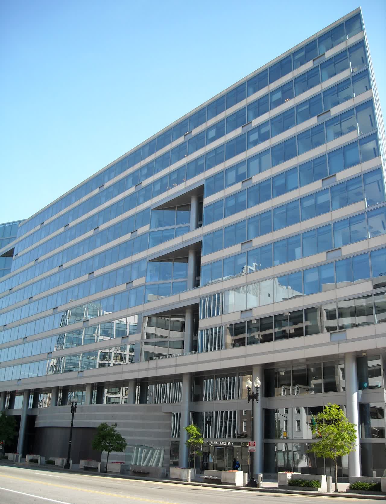 Front view of the International Monetary Fund headquarters on Pennsylvania Avenue in Washington, D.C., with the IMF name shield above the entrance