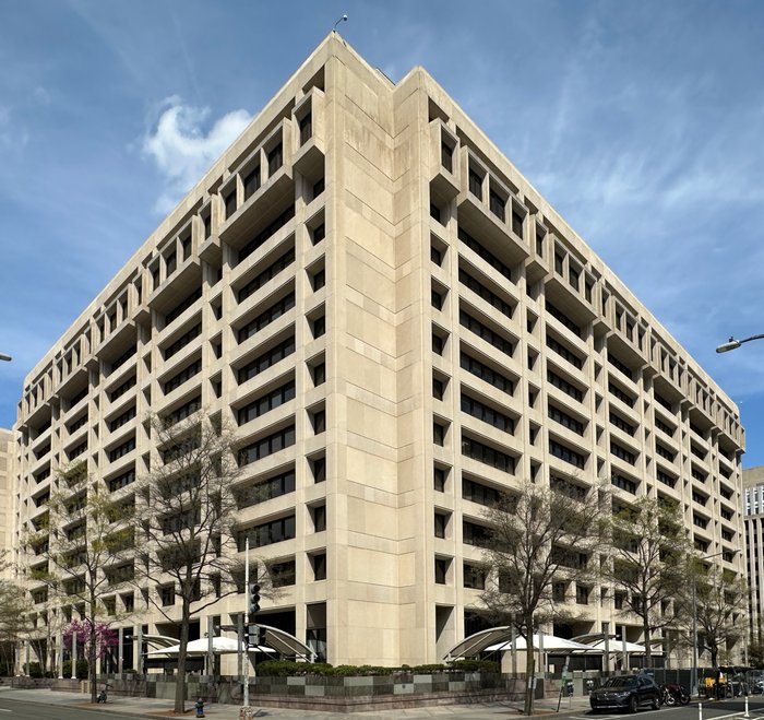 The International Monetary Fund headquarters in Washington, D.C., a large modern building with a glass and stone facade.