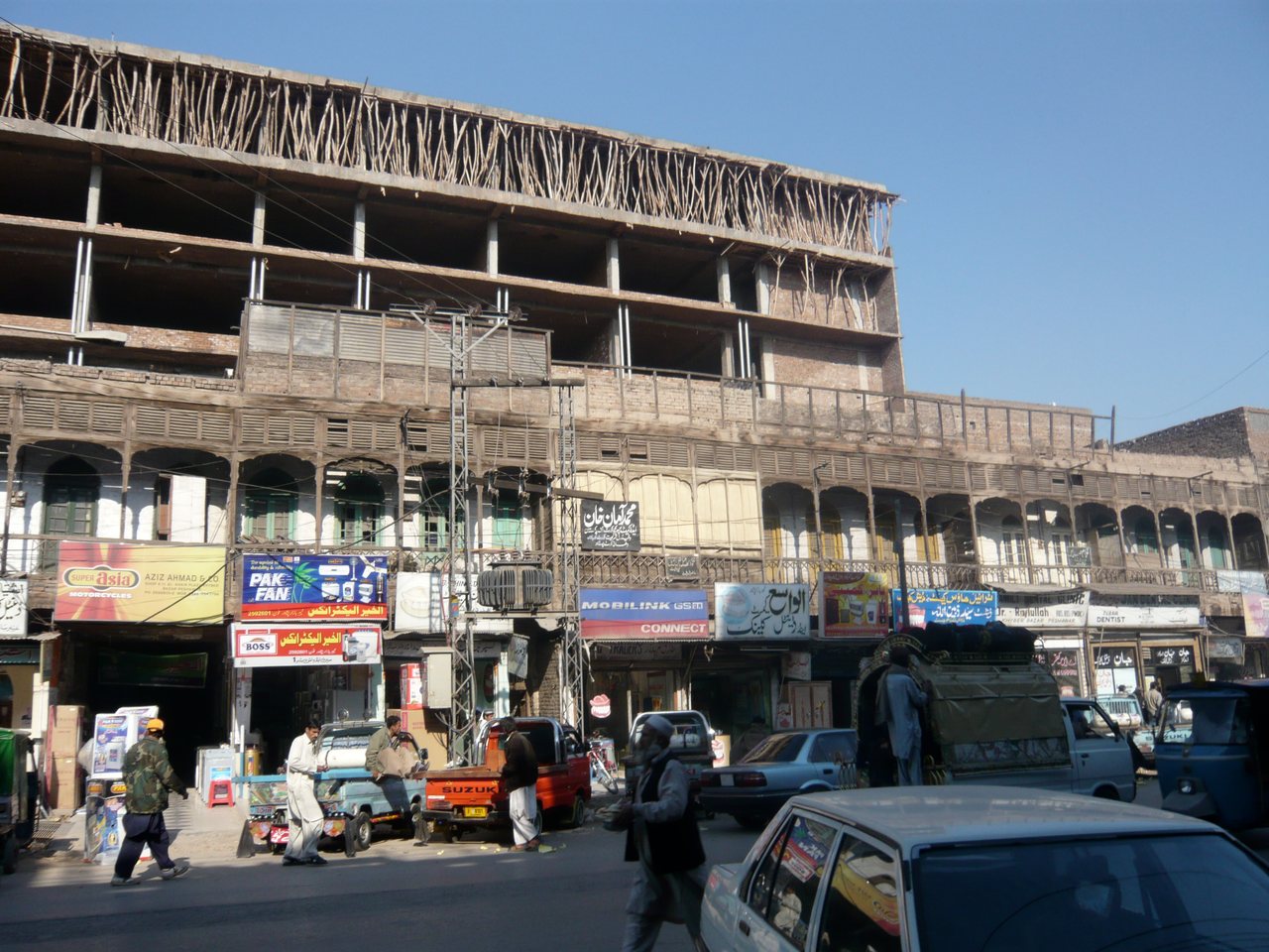 The old city of Peshawar, with low buildings and a street, seen in daylight