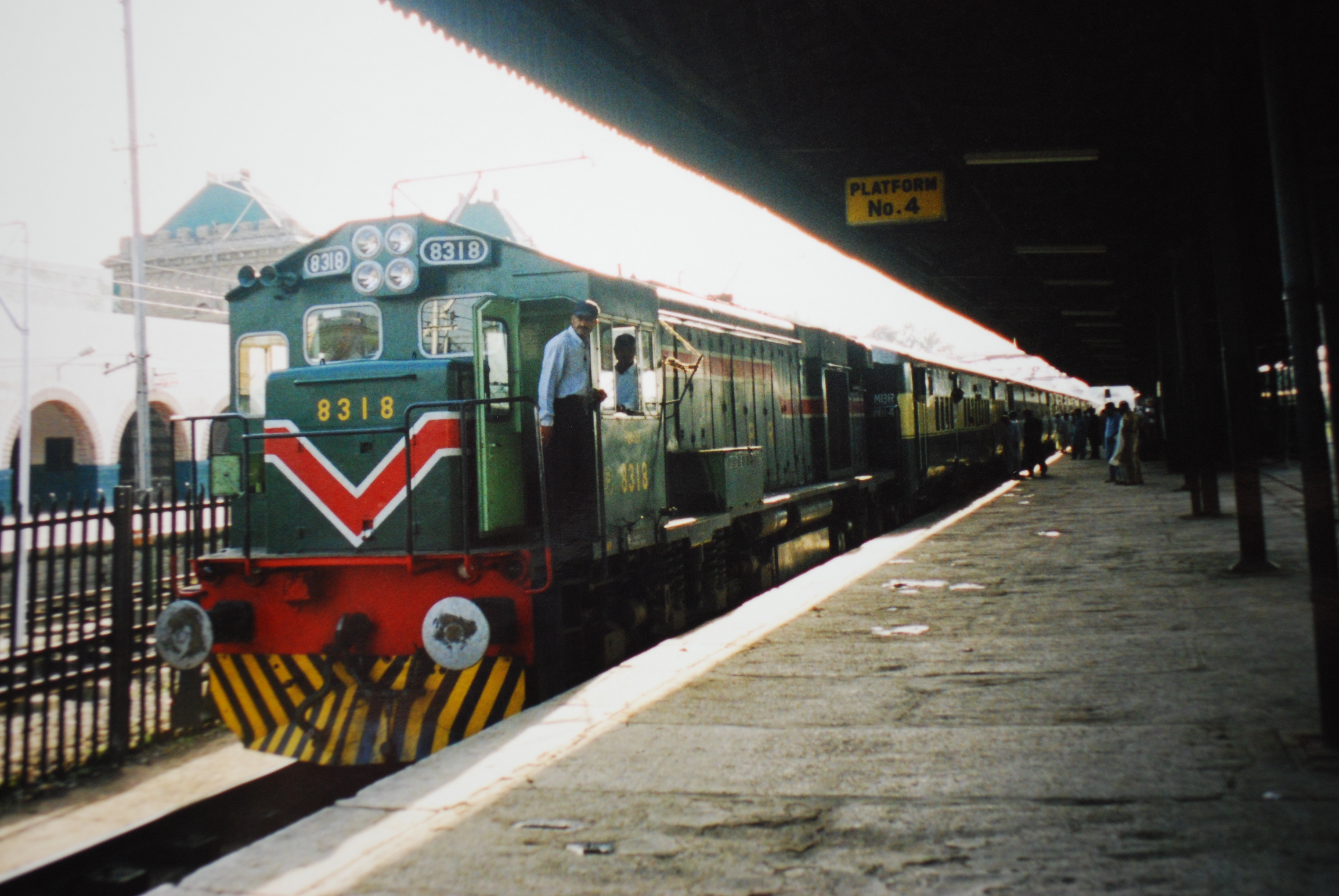 A Pakistan Railways diesel locomotive hauling the Mehar Express passenger train at Rawalpindi railway station, with carriages along the platform