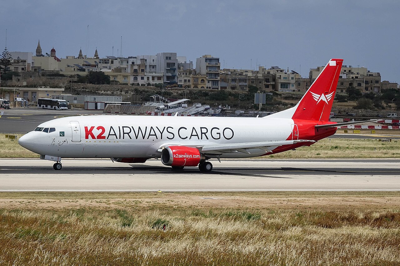 A K2 Airways Boeing 737-400 freighter on an airport apron in the airline's white and red livery.