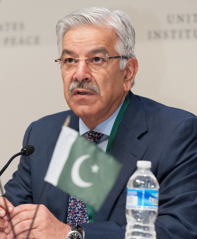 Defence Minister Khawaja Muhammad Asif seated in a dark suit at a conference table.