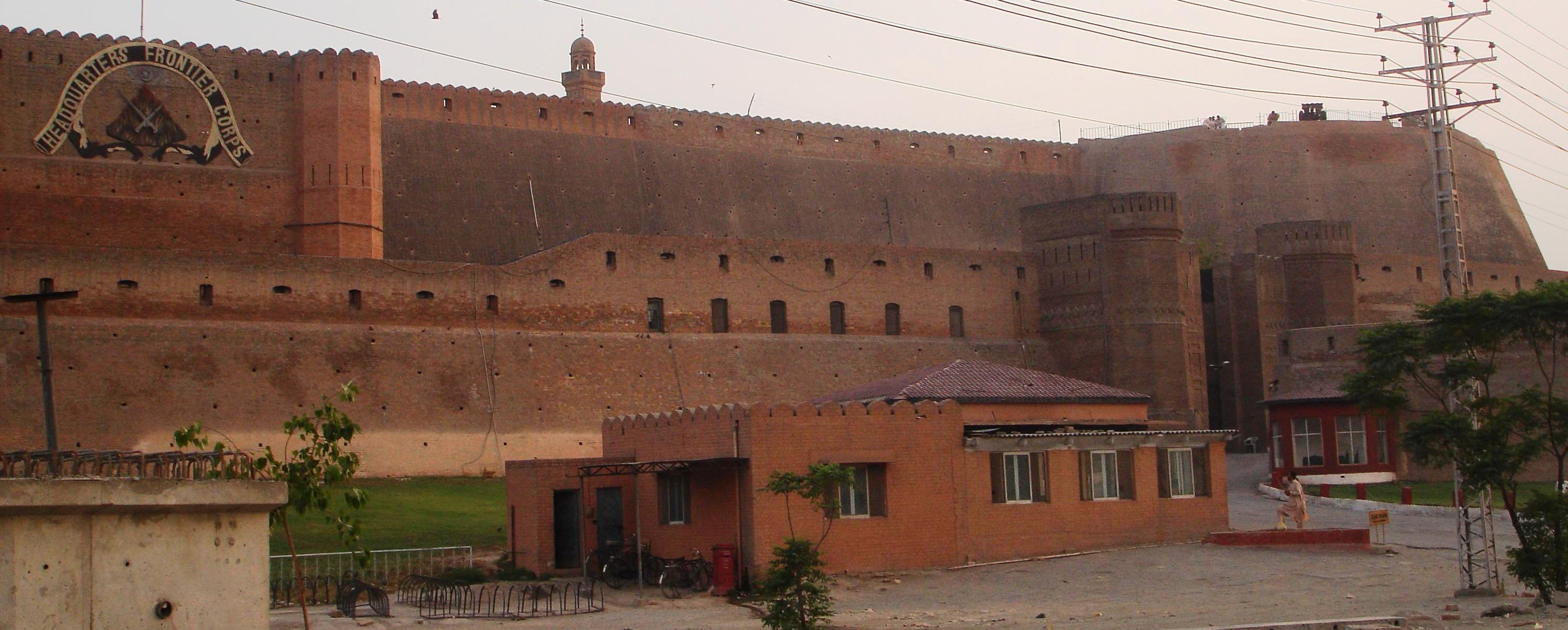 A wide view of Bala Hisar Fort in Peshawar, showing its stone ramparts, bastions and the surrounding city below.