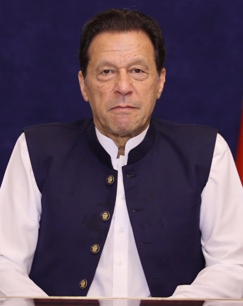 Imran Khan, founder of Pakistan Tehreek-e-Insaf, addressing supporters in a dark jacket.