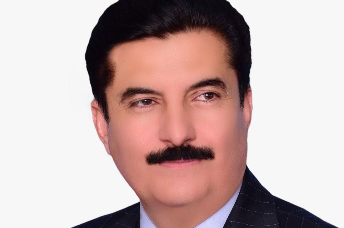 Head-and-shoulders official portrait of Faisal Karim Kundi, Governor of Khyber Pakhtunkhwa, wearing a dark pinstripe suit and a patterned blue tie against a white background.