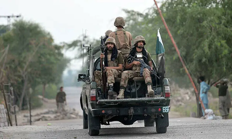 Pakistan Army personnel travel in a military vehicle