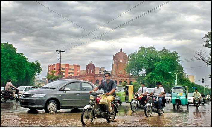 A street in Lahore during heavy rain, shown as a contextual image of monsoon weather in the city.