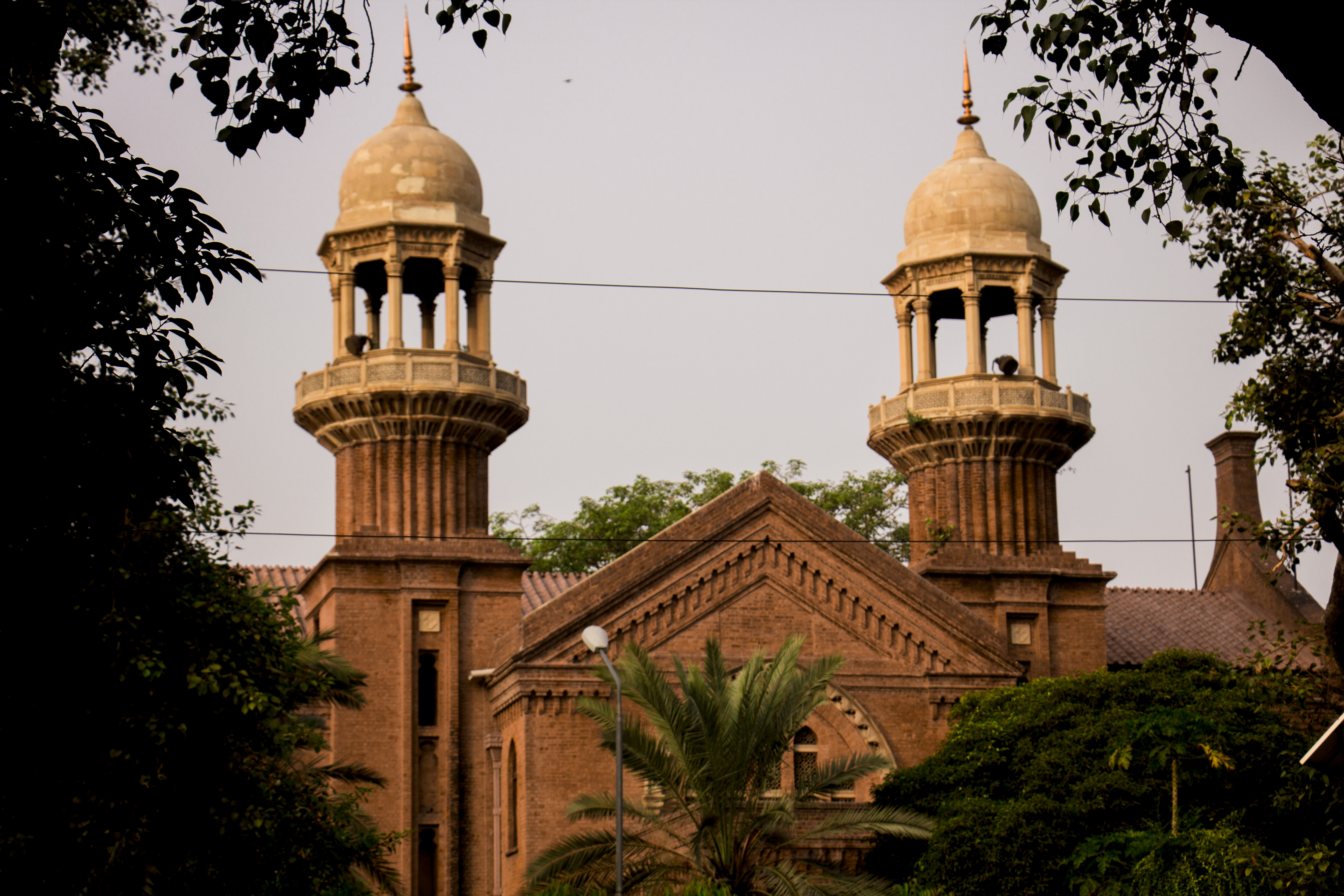 The sandstone facade of the Lahore High Court building, with arched windows and a central entrance.