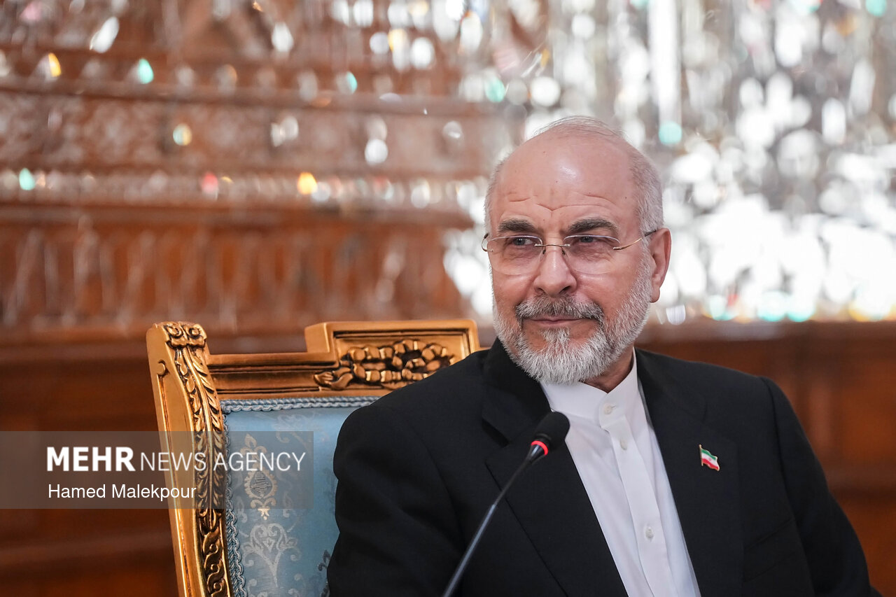 Field Marshal Asim Munir seated in an armchair across a table from Iranian parliament speaker Mohammad Bagher Ghalibaf during a meeting in Tehran.