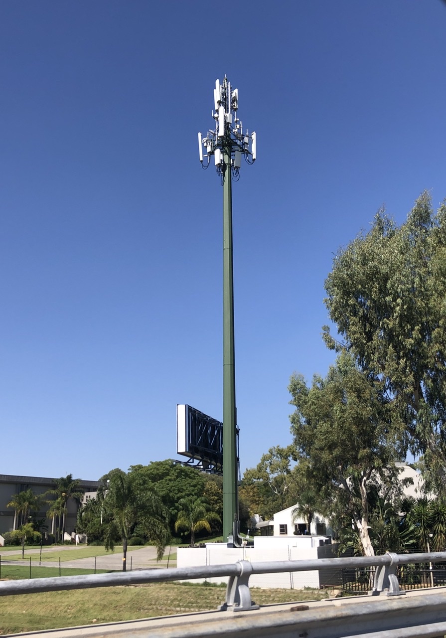 A 5G cellular panel antenna mounted on a tower in Johannesburg, South Africa, photographed against a clear sky.