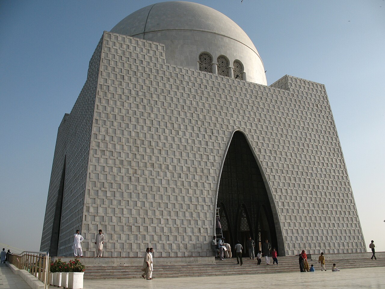 The white marble Mazar-e-Quaid mausoleum in Karachi beneath a clear sky.
