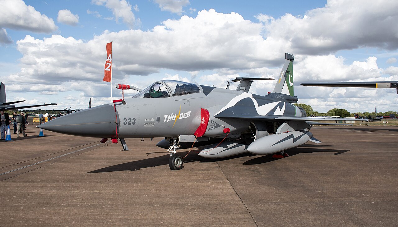 A Pakistan Air Force JF-17 Thunder fighter jet taxiing on an airfield.