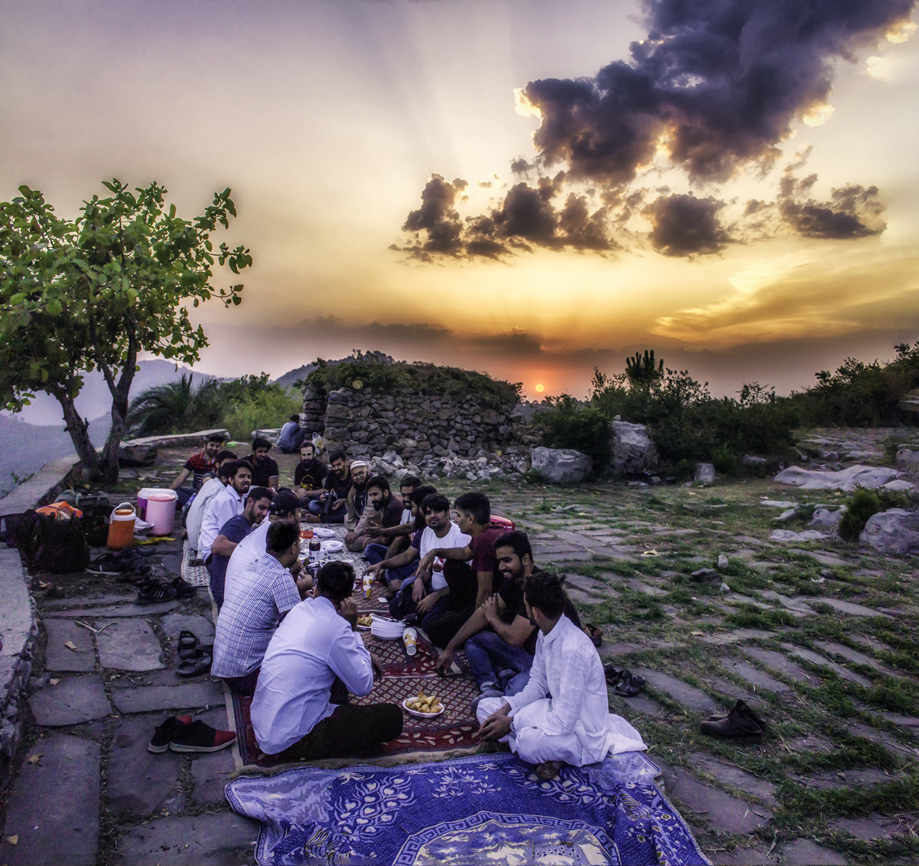 Friends prepare to break their fast with an Iftar meal at dusk on the Margalla Hills in Islamabad during Ramadan.