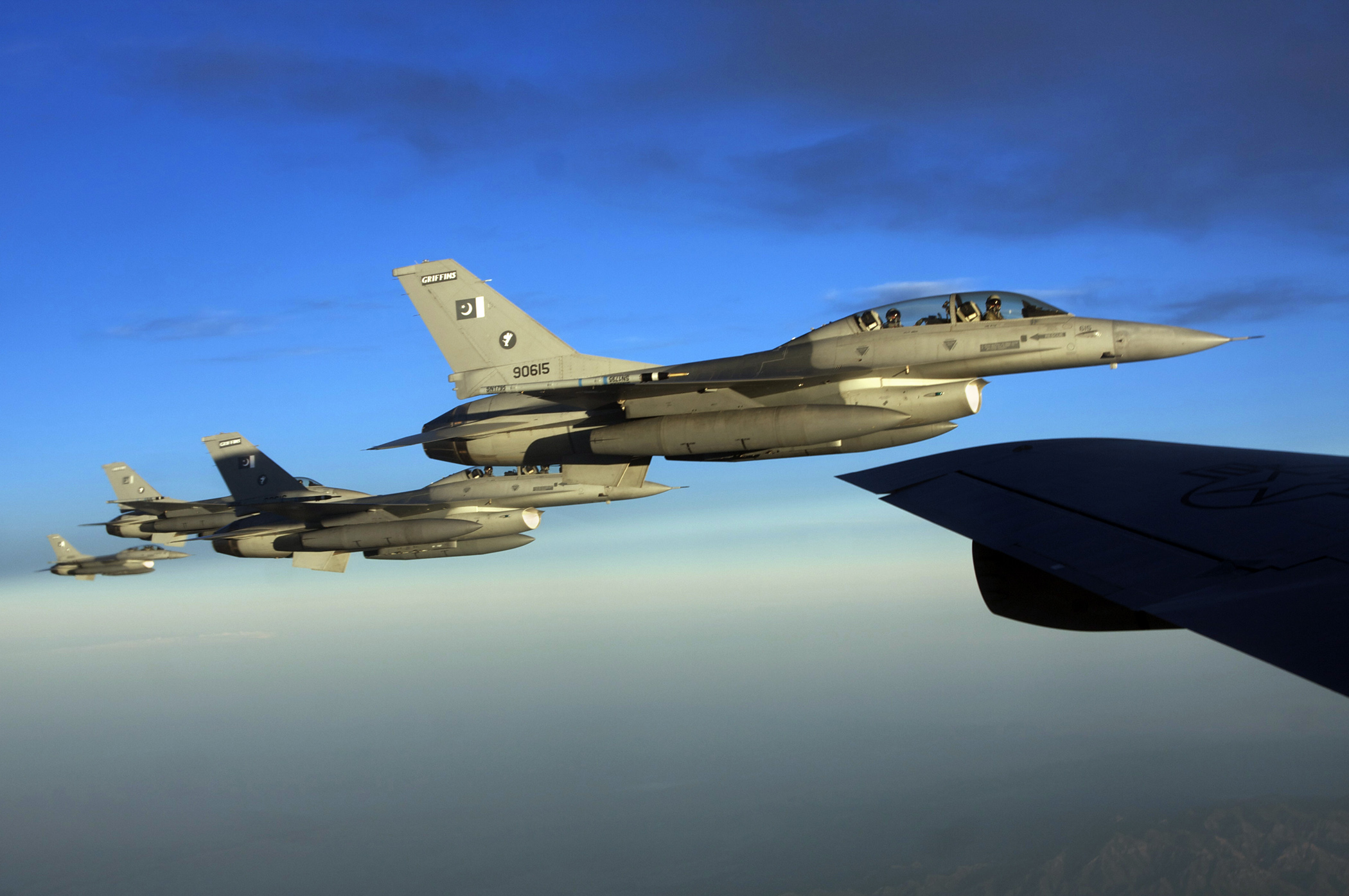 A Pakistan Air Force F-16 fighter jet refuelling from a tanker aircraft in flight.