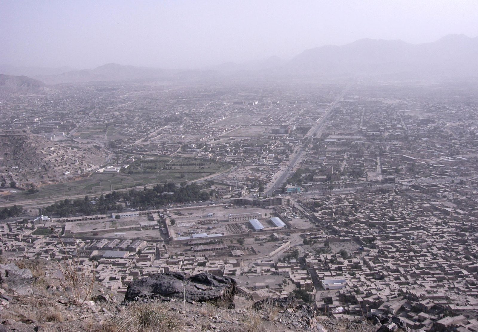 A wide view over Kabul's low-rise cityscape and surrounding hills seen from the city's TV Hill viewpoint.