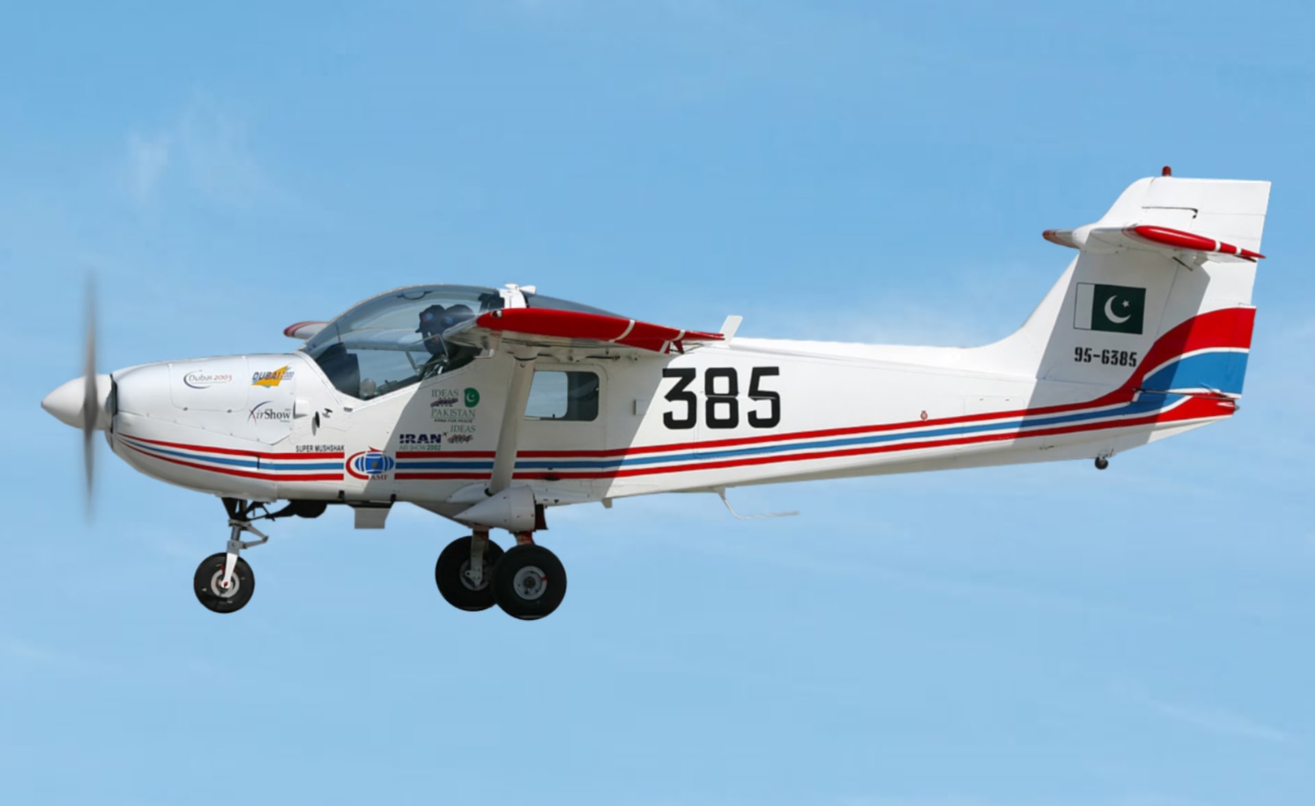 A Pakistan MFI-17 Super Mushshak single-engine trainer aircraft in flight, viewed from the side against a clear sky.