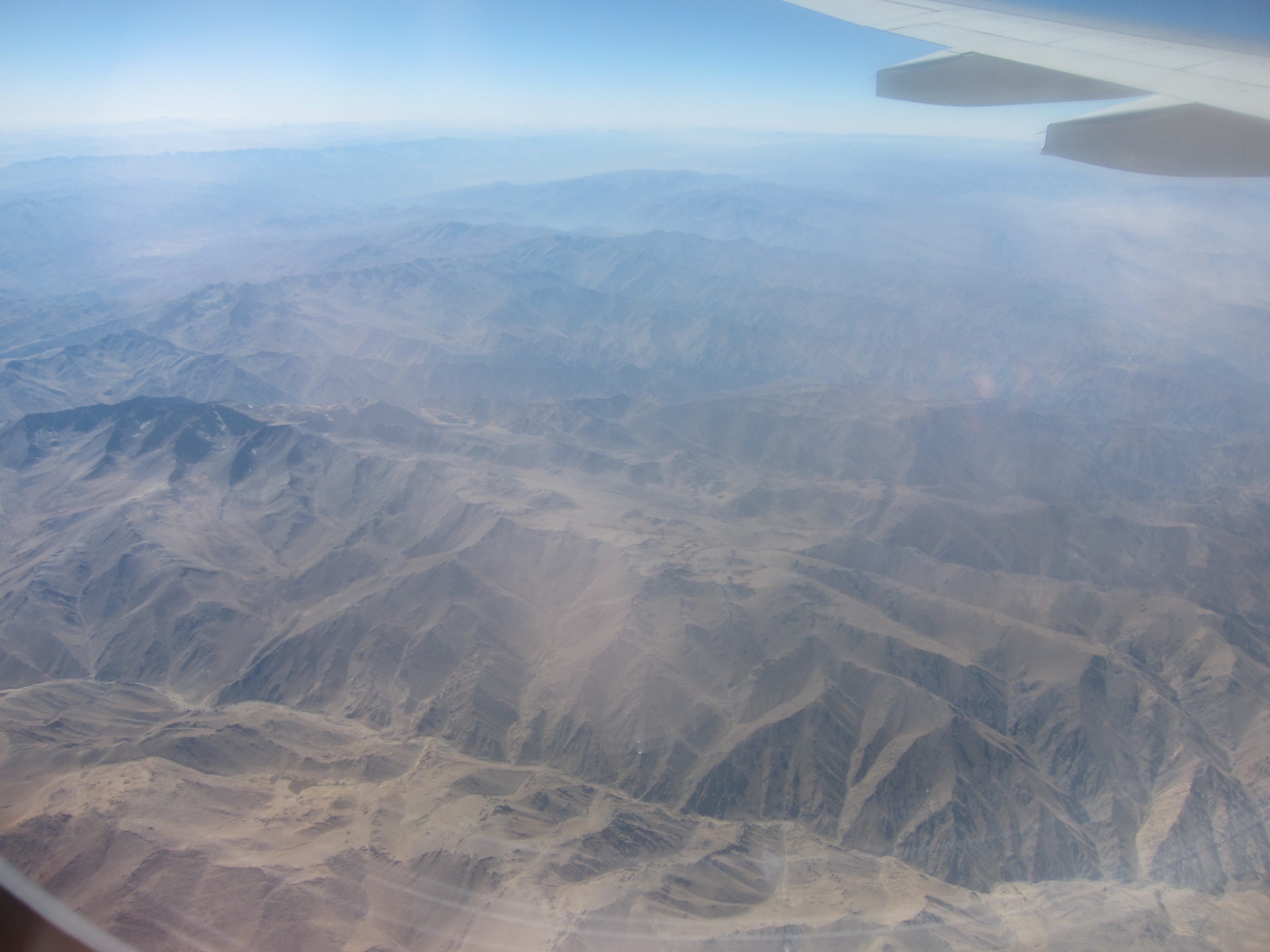 An aerial view of the snow-capped Hindu Kush mountain range in Afghanistan.