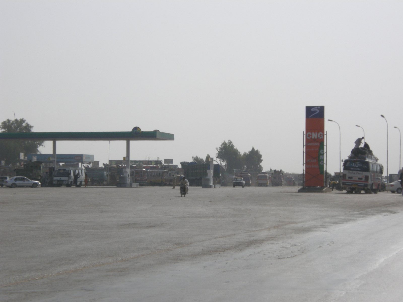 Vehicles queue at a Pakistan State Oil petrol and CNG station beside a road near Hyderabad, Sindh.