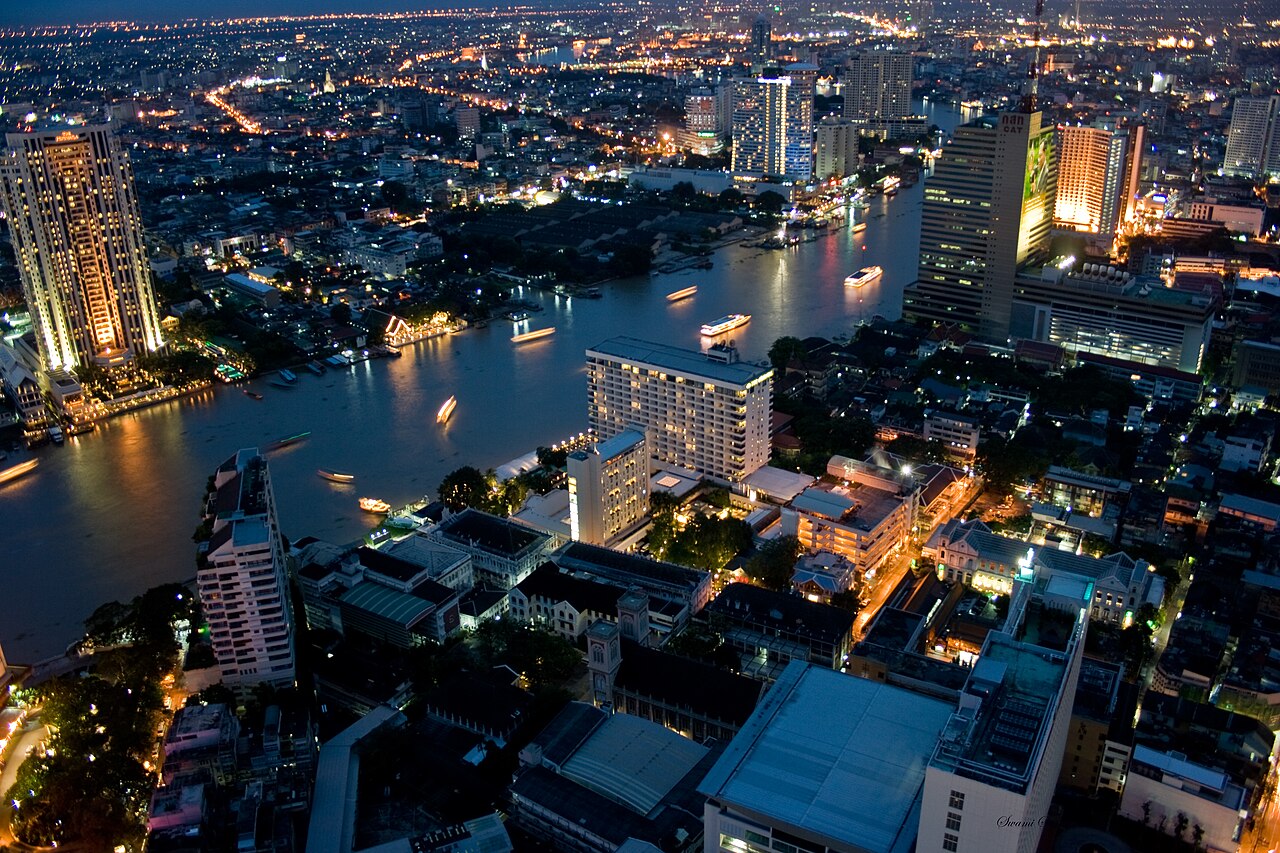 Bangkok skyline and the Chao Phraya River lit up at night, viewed from the State Tower in 2008.