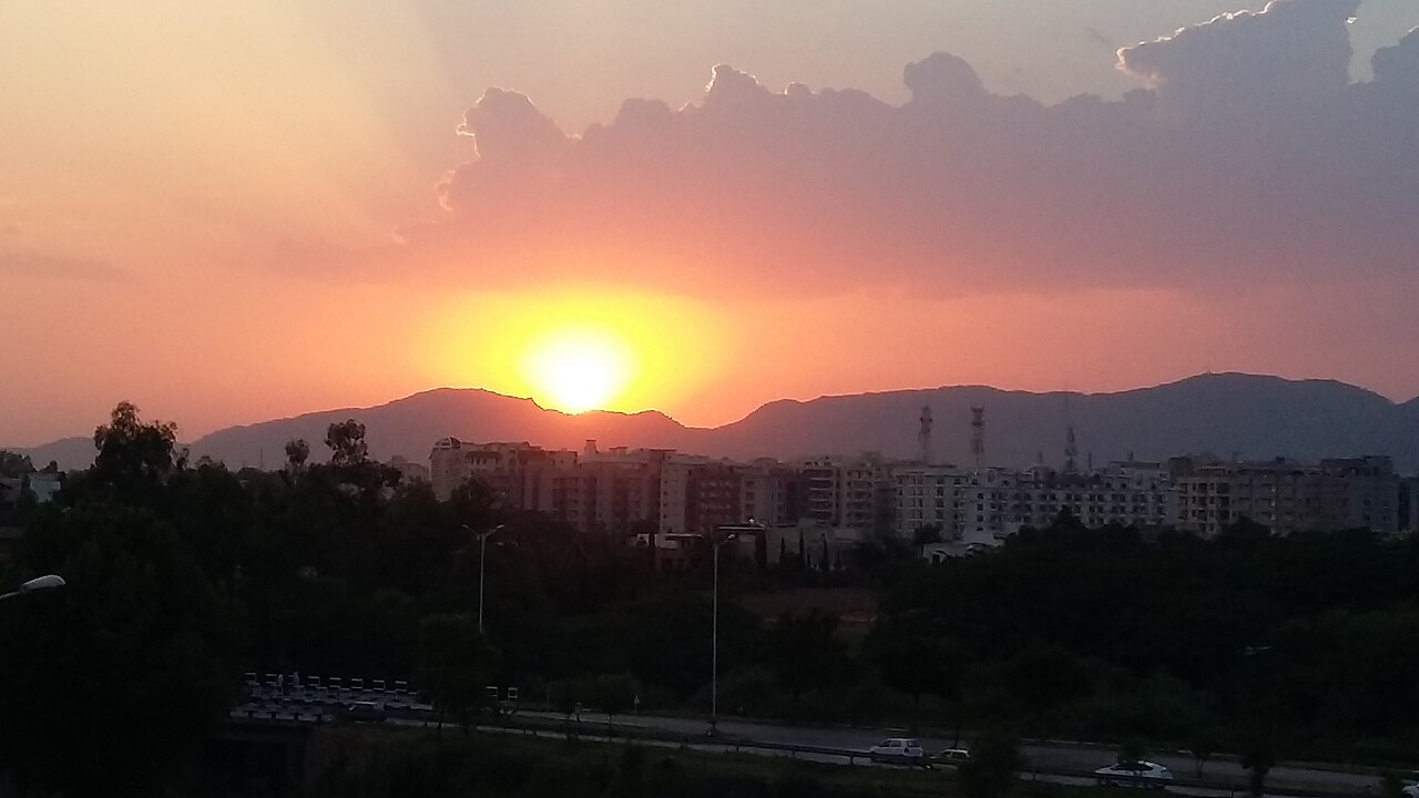 A bright, intense sun seen from a balcony in Islamabad.