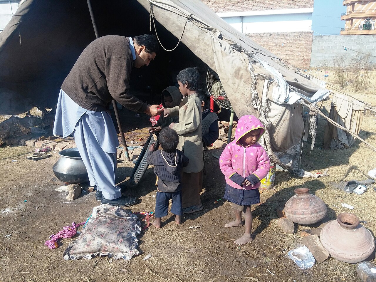 A health worker inspects children during a polio vaccination campaign in Pakistan.