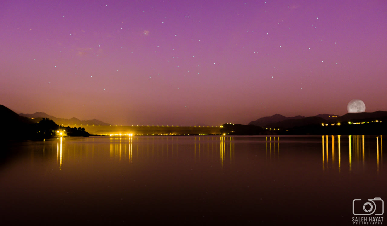 Tarbela Dam and its reservoir on the Indus River photographed at night.