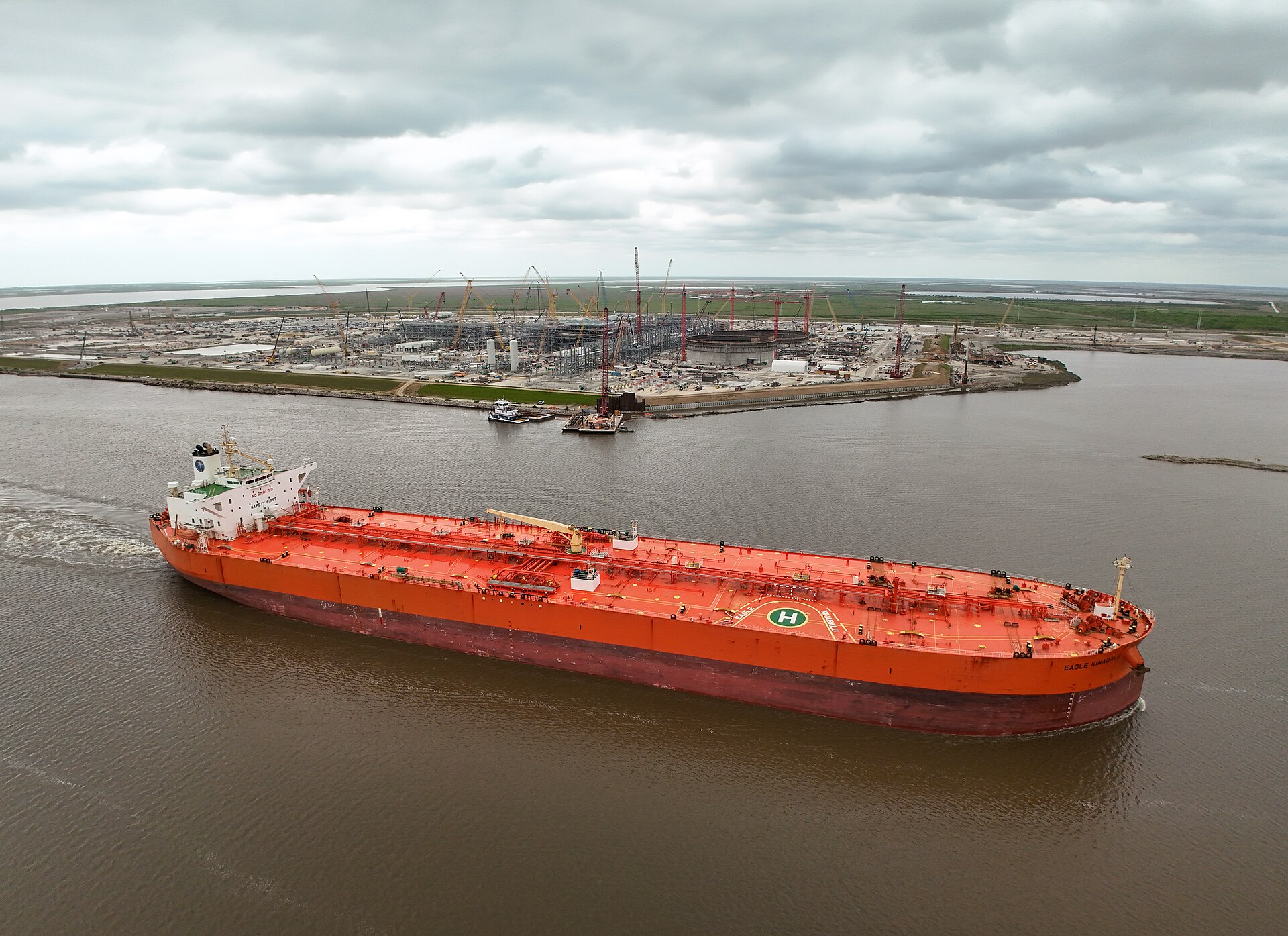 A large crude oil tanker under way on open water, seen from the side.