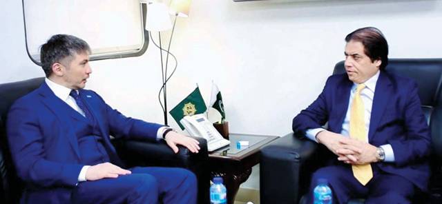Pakistan's railways minister and Kazakhstan's ambassador seated for a meeting in an Islamabad office.