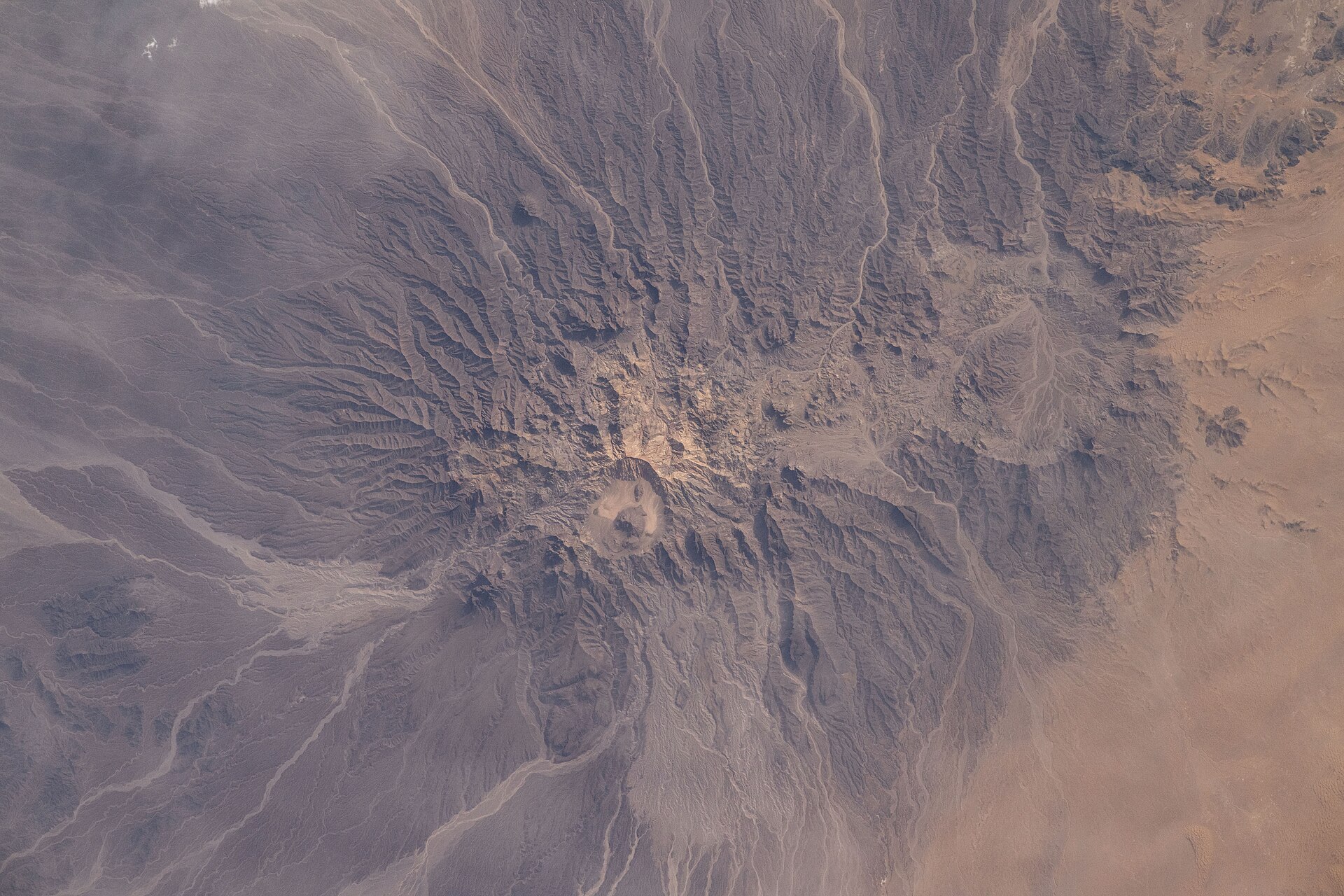 A mud volcano and arid ridges of Pakistan's western Chagai district in Balochistan, photographed from the International Space Station about 258 miles above central Asia.