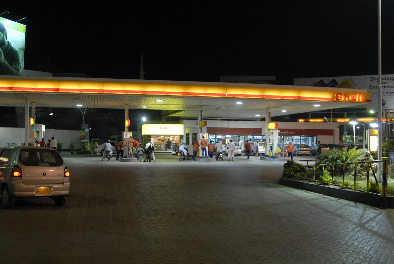 A retail fuel station in Karachi with pumps under a canopy.