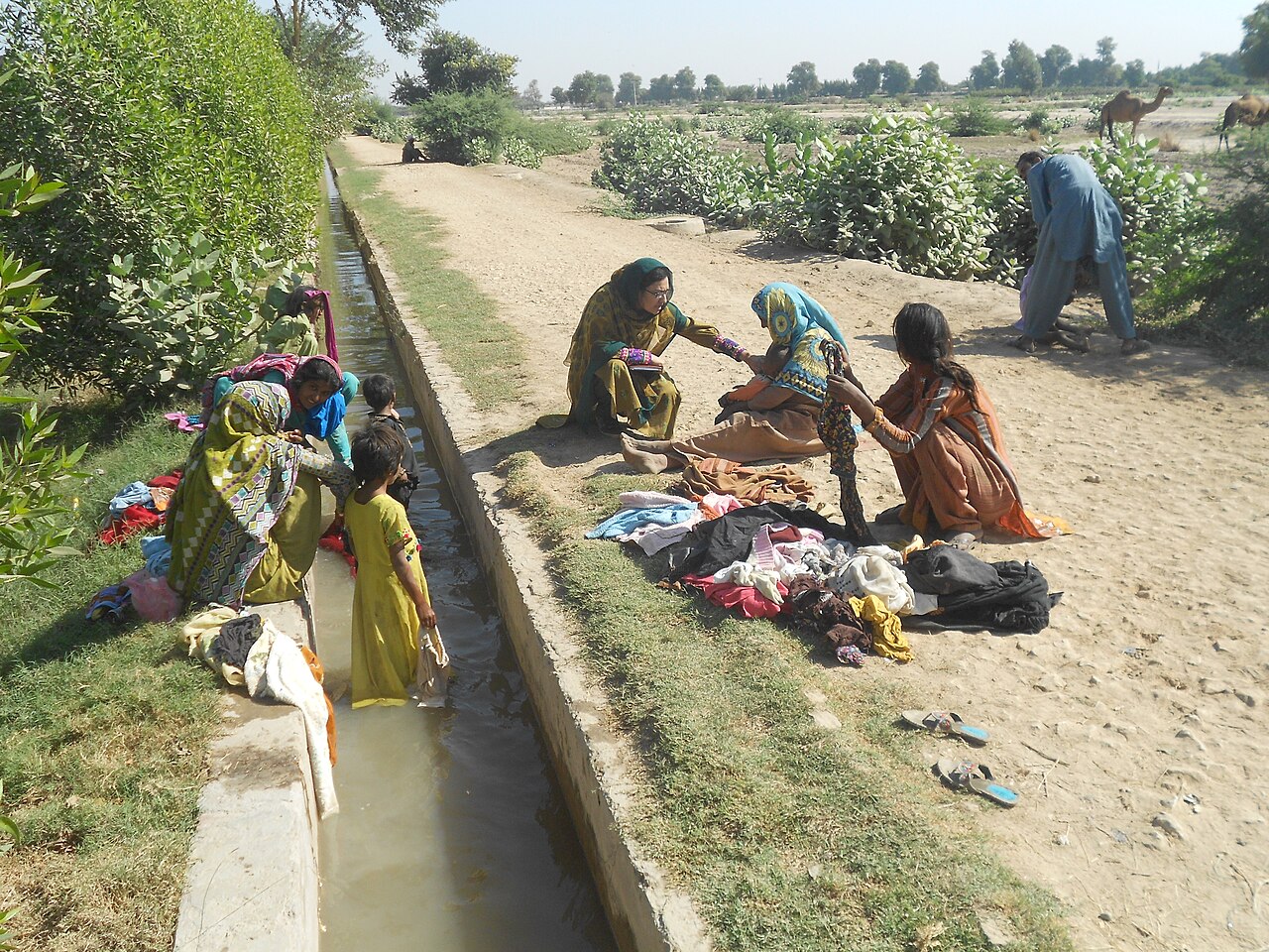 A health worker checking a child's finger for vaccination marks during a polio drive in Pakistan