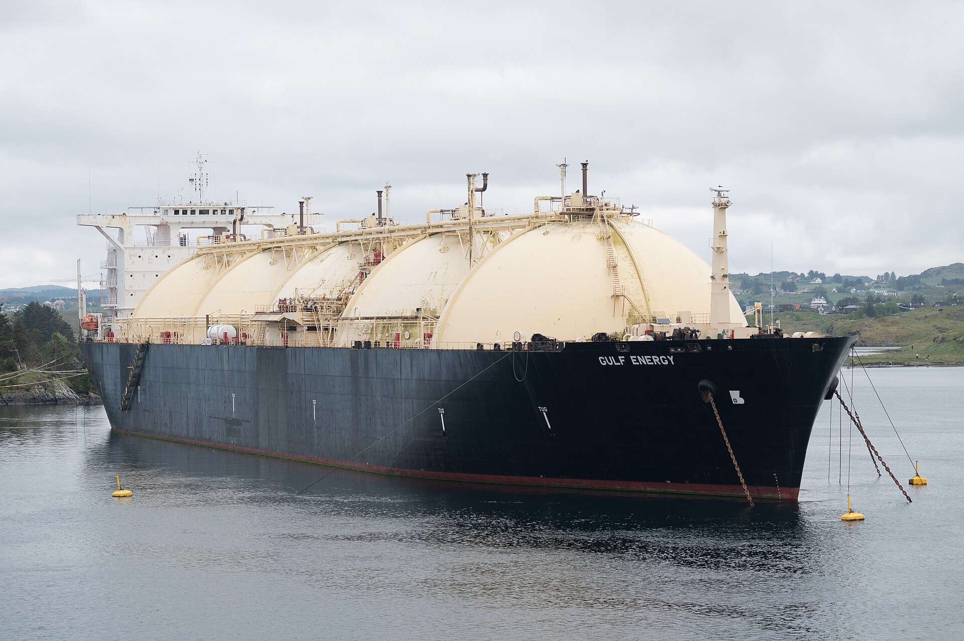 The LNG tanker Gulf Energy, with four spherical tanks on deck, moored in a Norwegian strait.