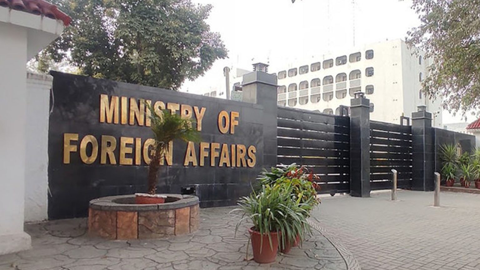 The Pakistan Foreign Office building in Islamabad, showing its light-coloured facade and the national flag