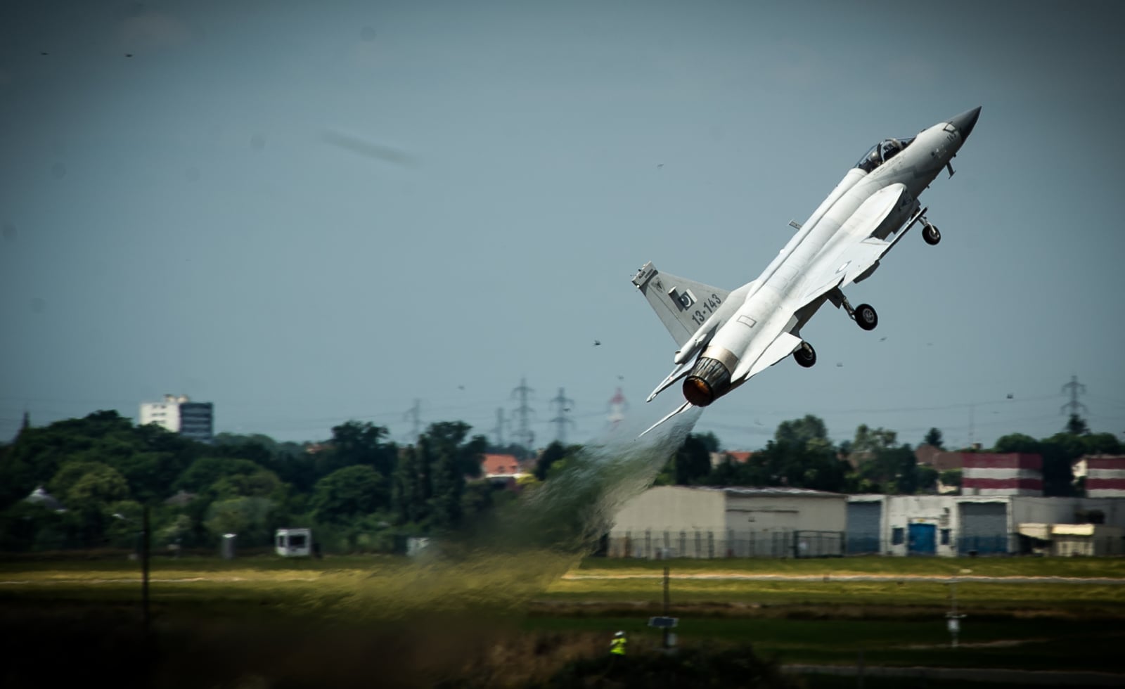 A Pakistan Air Force JF-17 Thunder fighter jet on the ground at an air show.