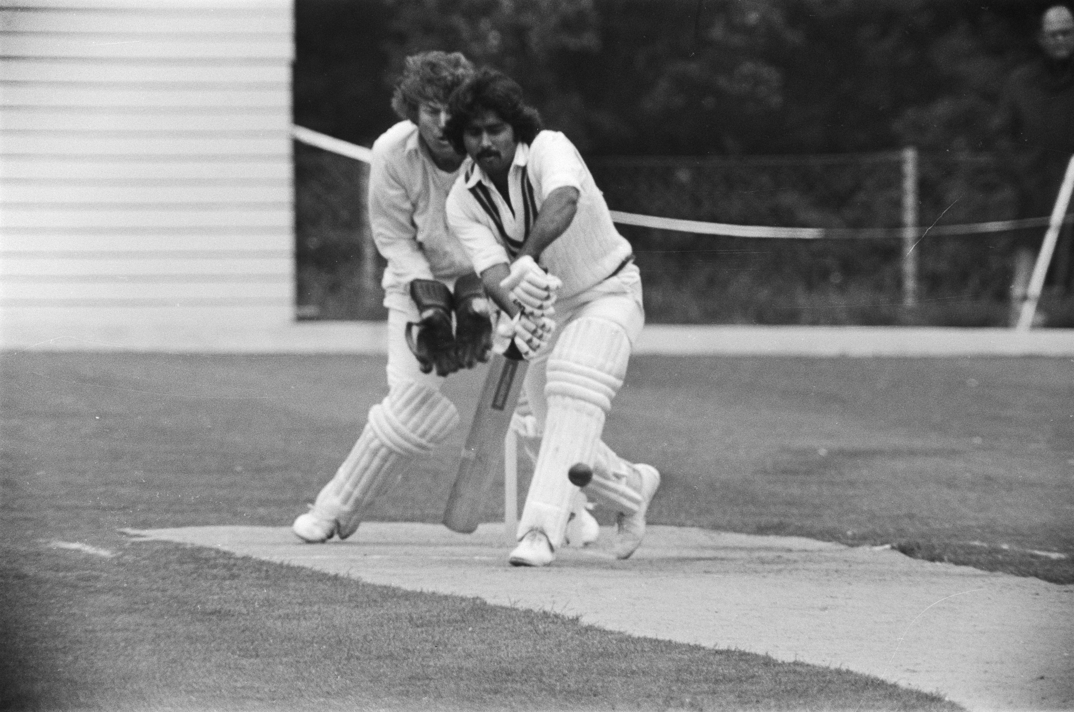 Cricketers in whites on the field during a Netherlands versus Pakistan match.